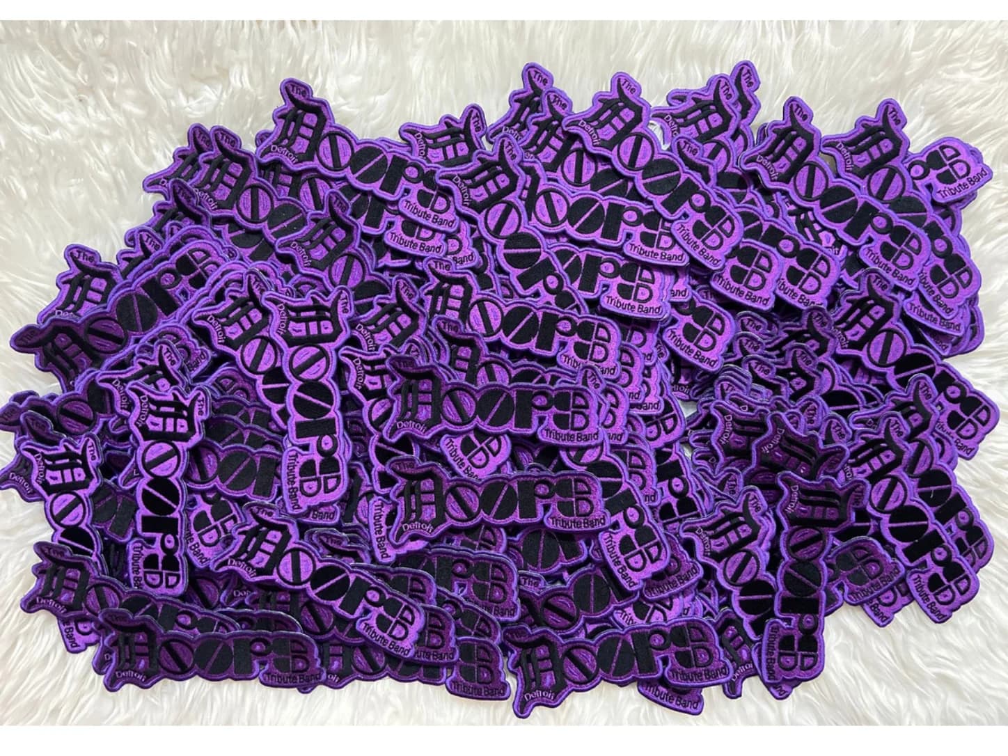 Purple and black custom-shaped lettering patches