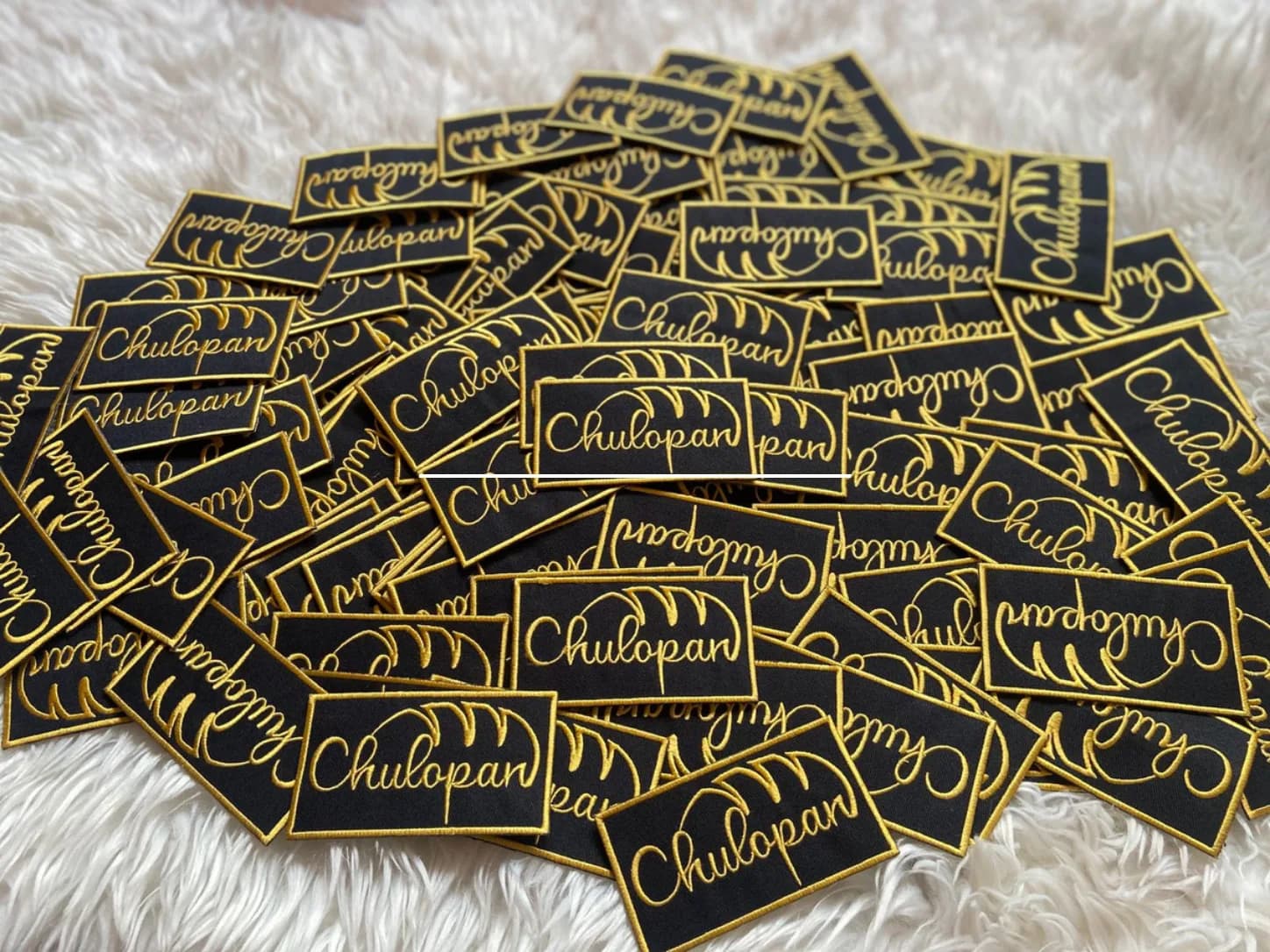Black rectangular patches with gold script and matching borders